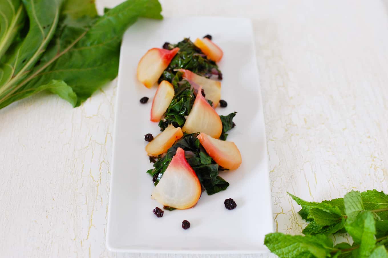 Simple warm salad of beet greens and beets with currants, lemon zest, and mint. Make this beet green salad by itself or toss with pasta for a complete meal.