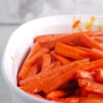 carrots braised in carrot juice in a casserole dish