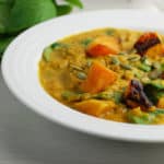 red lentil squash stew with pepitas in a bowl