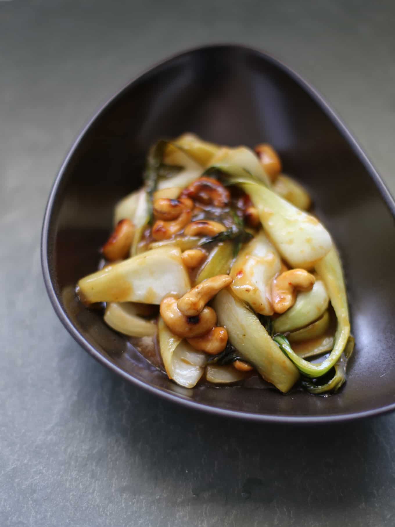 Chinese garlic sauce with bok choy and cashews in a bowl