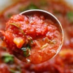 tomato basil sauce being ladled