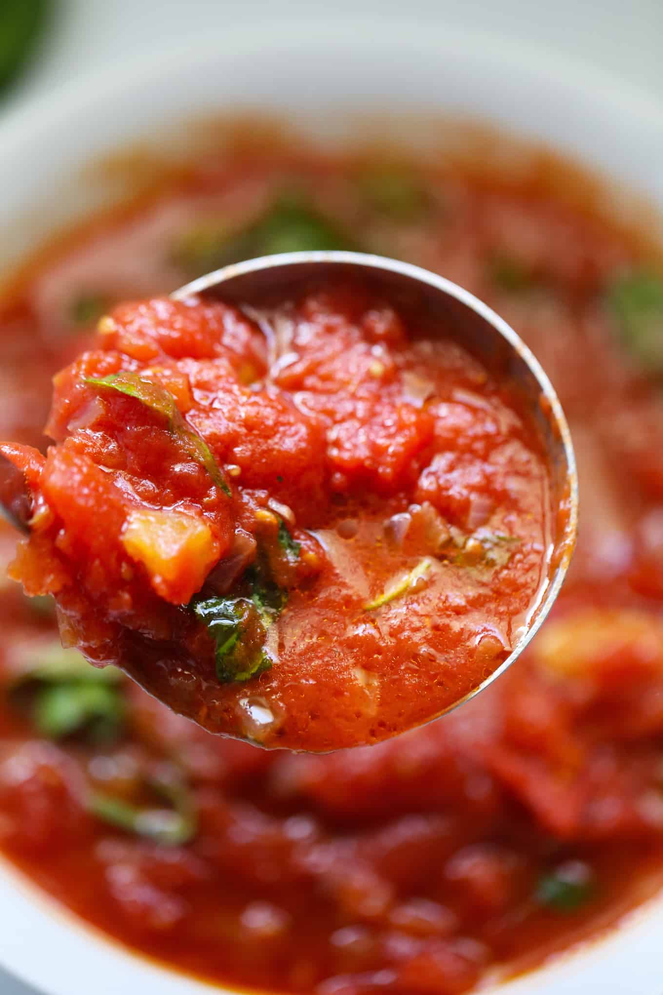 tomato basil sauce being ladled