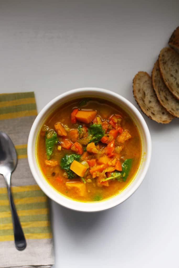 soup bowl with sweet potato, squash, turmeric, kale, and other vegetables