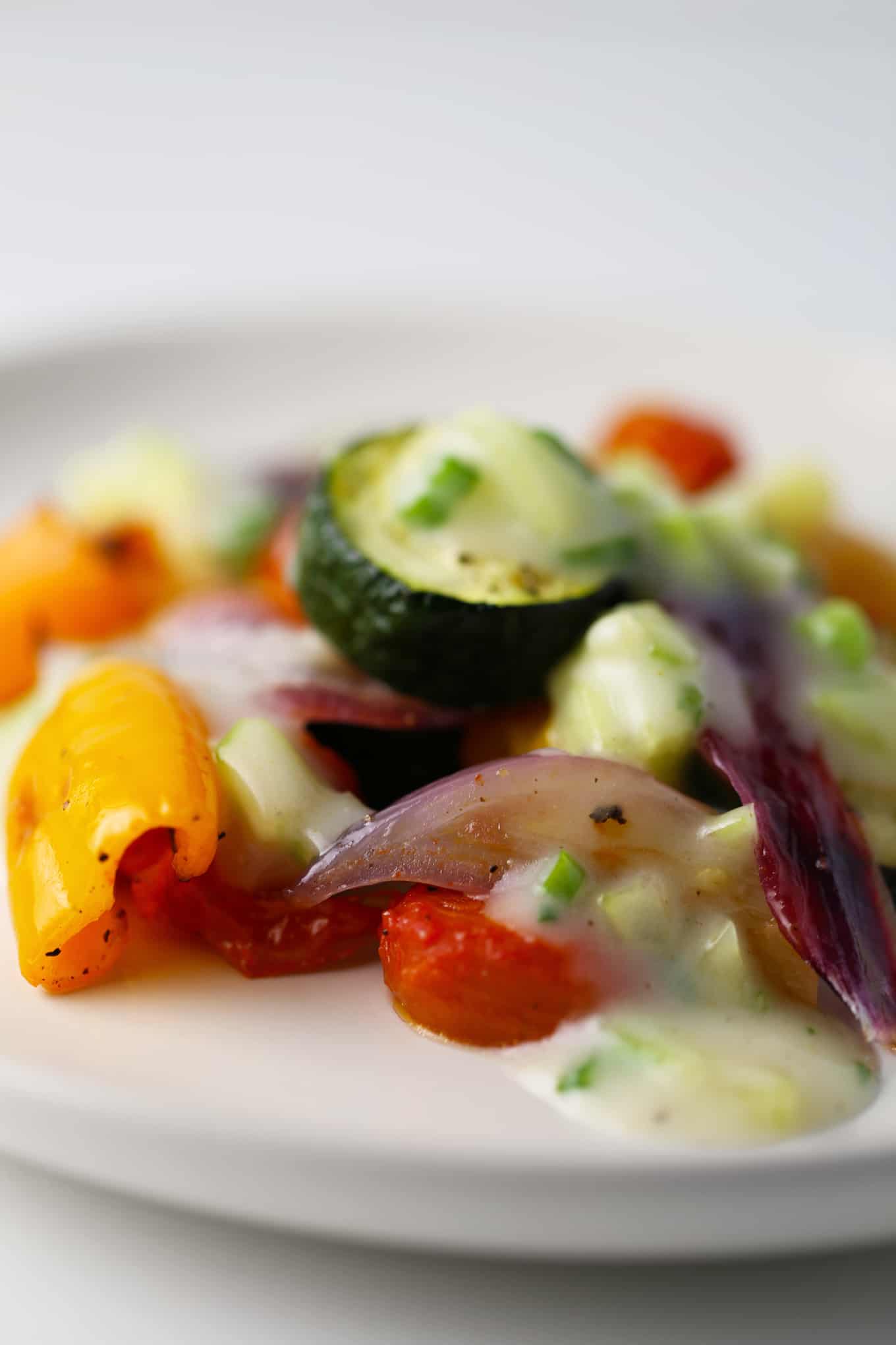 Vegan cucumber yogurt sauce over roasted vegetables