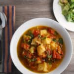 Bowl of tomato bread soup and caesar salad