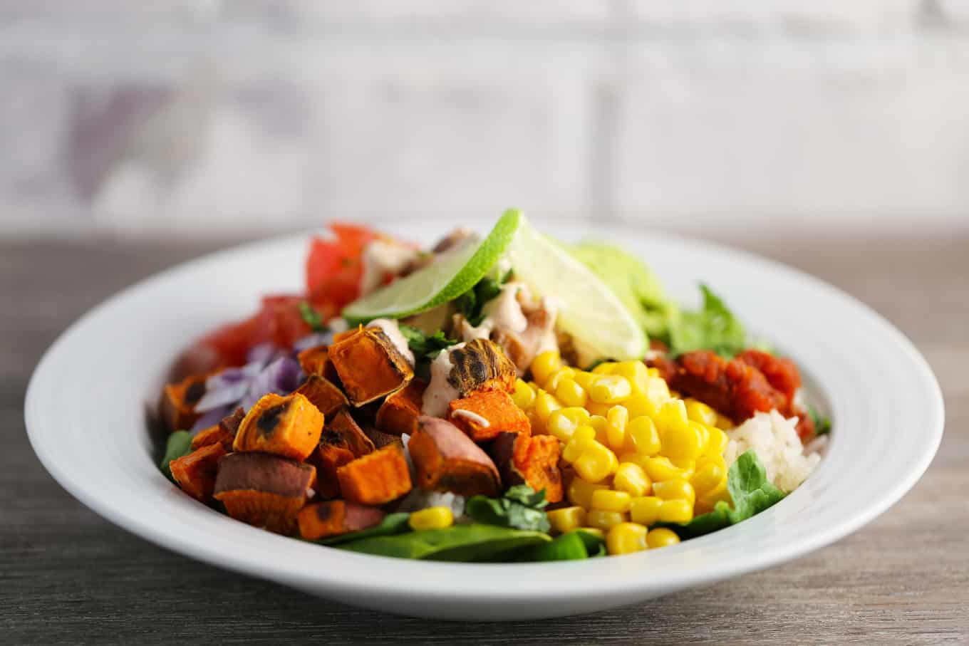Refried Beans and Rice Bowl with Veggies and Smoky Cajun Sauce One Bite Vegan