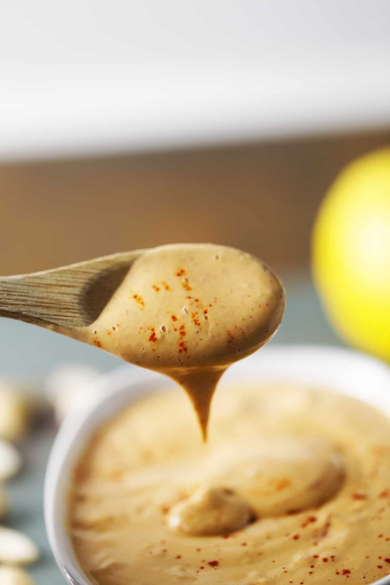 A wooden spoon that has been dipped in smoky Cajun sauce.
