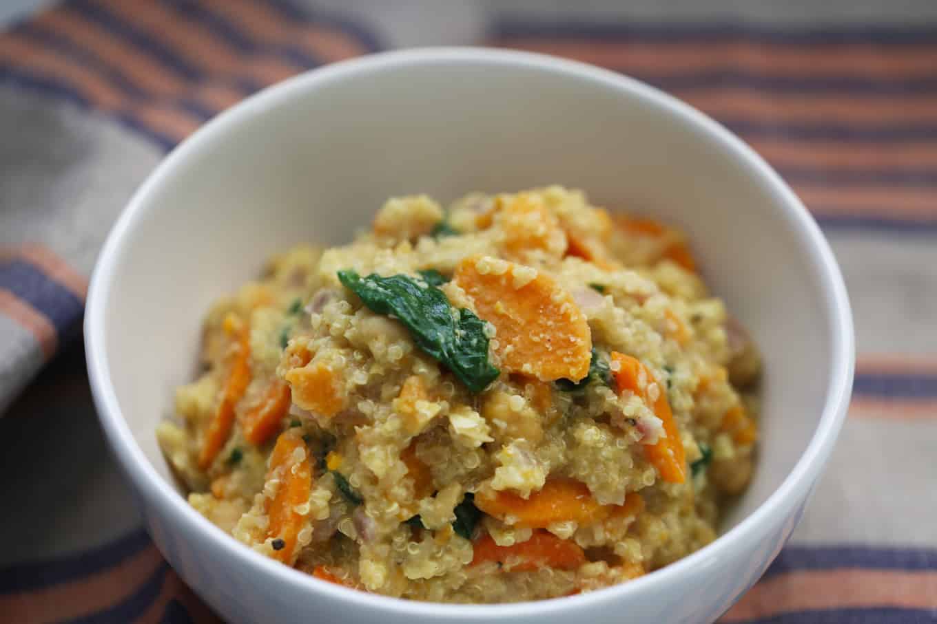 A bowl of quinoa with sweet potato and spinach.