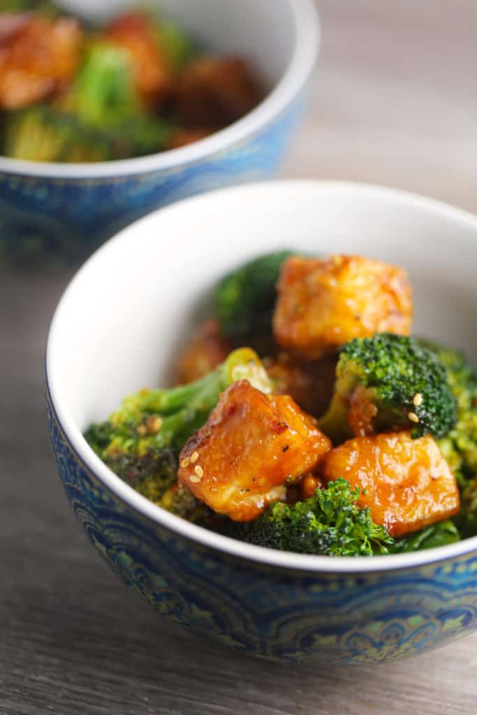 A bowl of tofu and veggies with General Tso's sauce