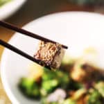 Chopsticks with sesame tofu.