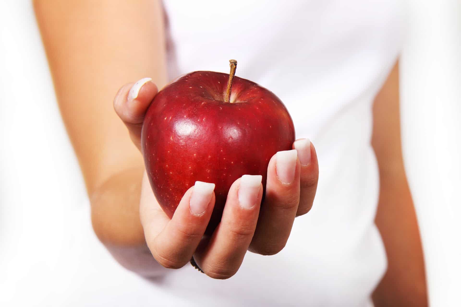 woman holding a red apple